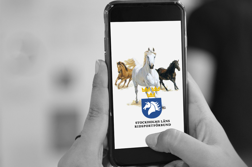 Mobiltelefon med hästar och StRF logo 